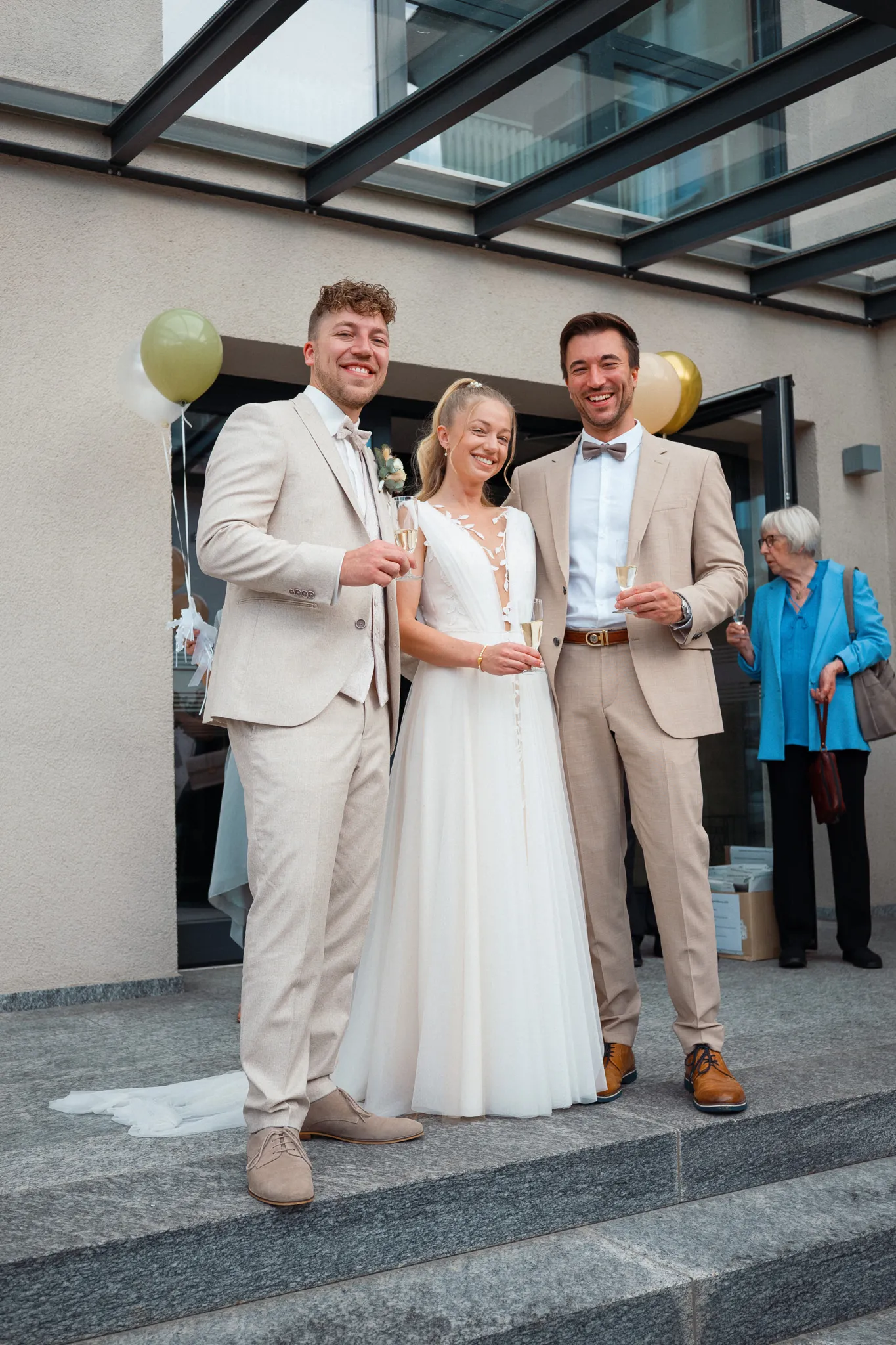 Franziska und Daniel stehen mit einem Gast vor dem Standesamt.