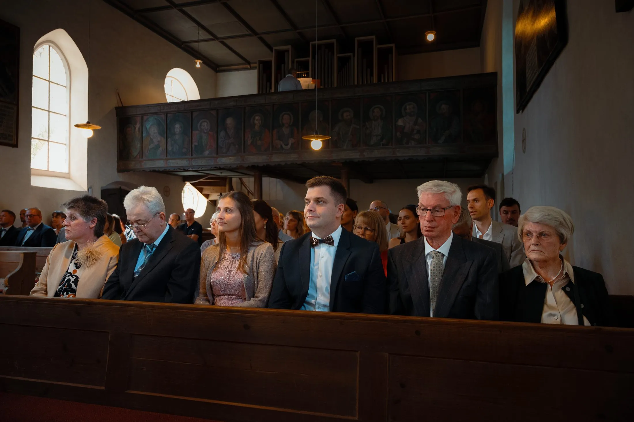Gäste und Brautpaar während der Trauung in der Kirche.